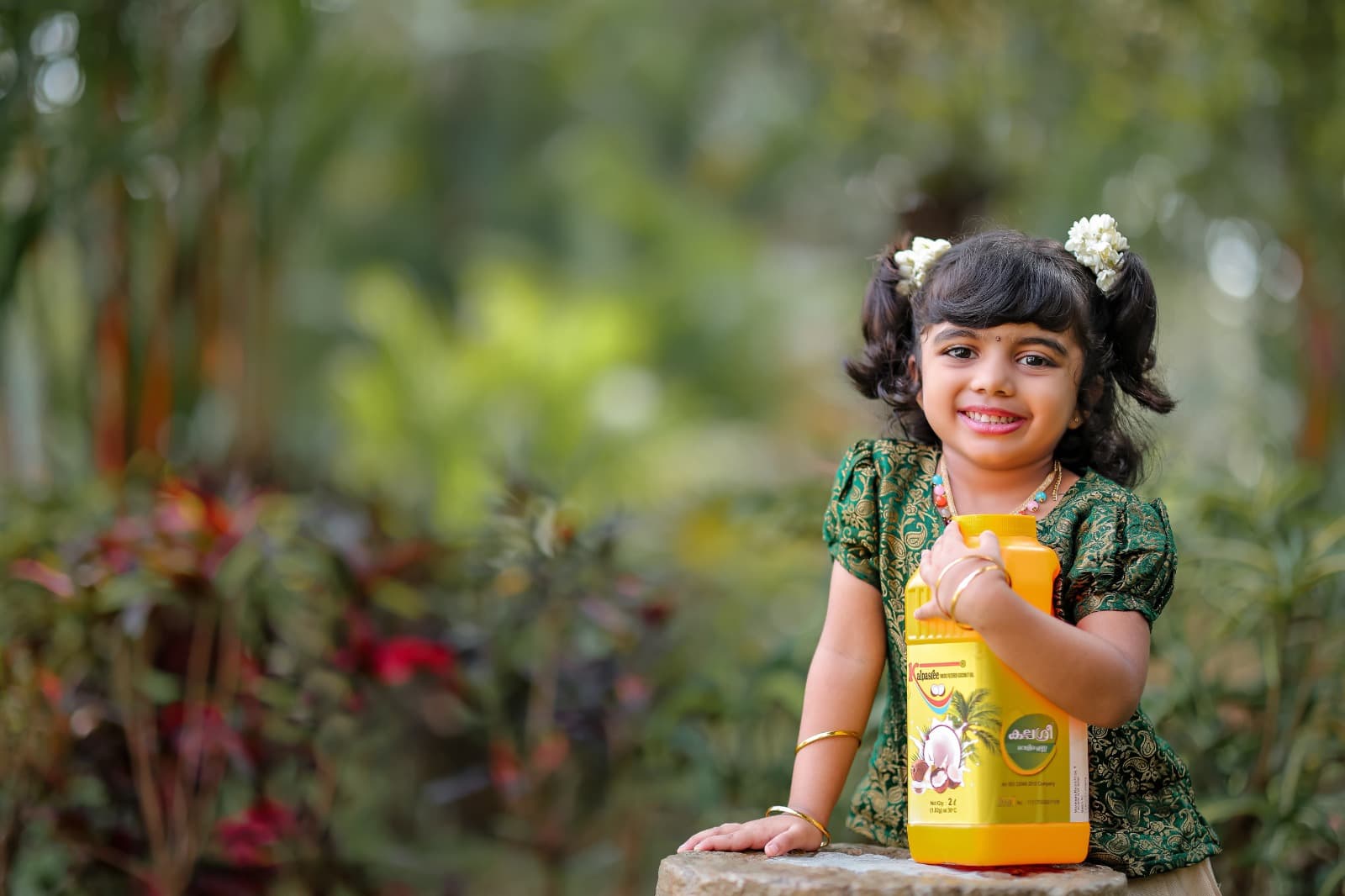A child holding a Kalpasree 2 litre can
