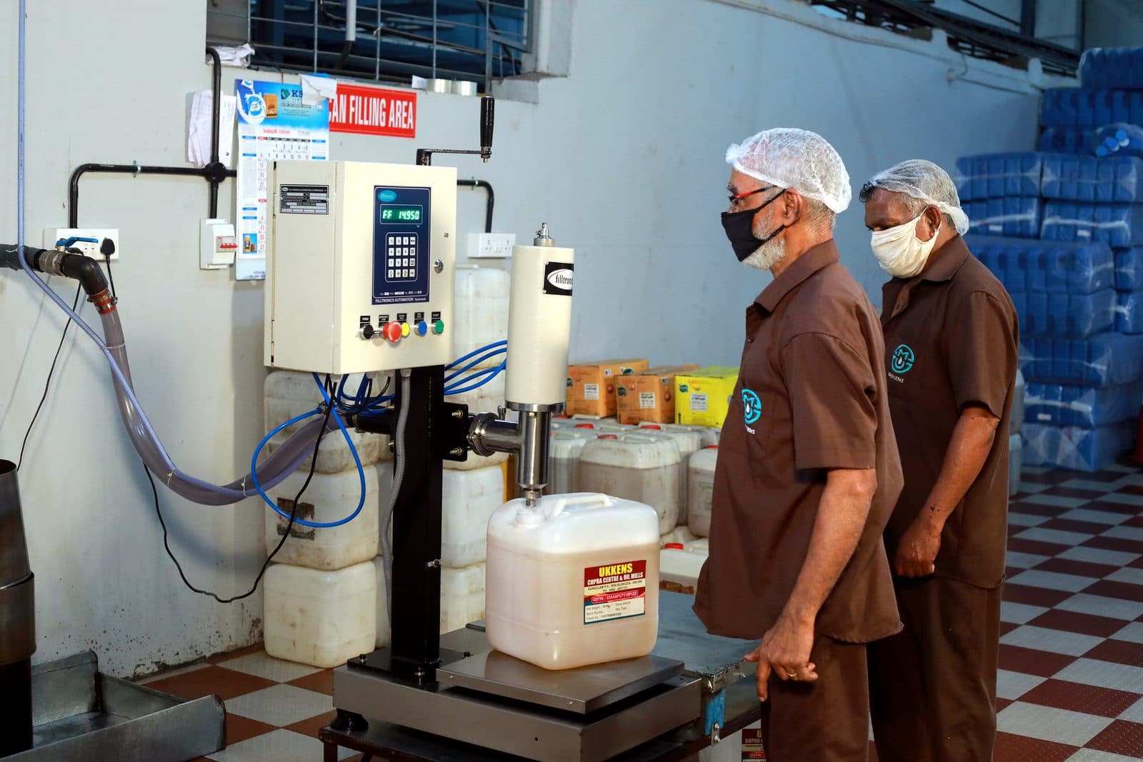 Filling coconut oil into cans on the line