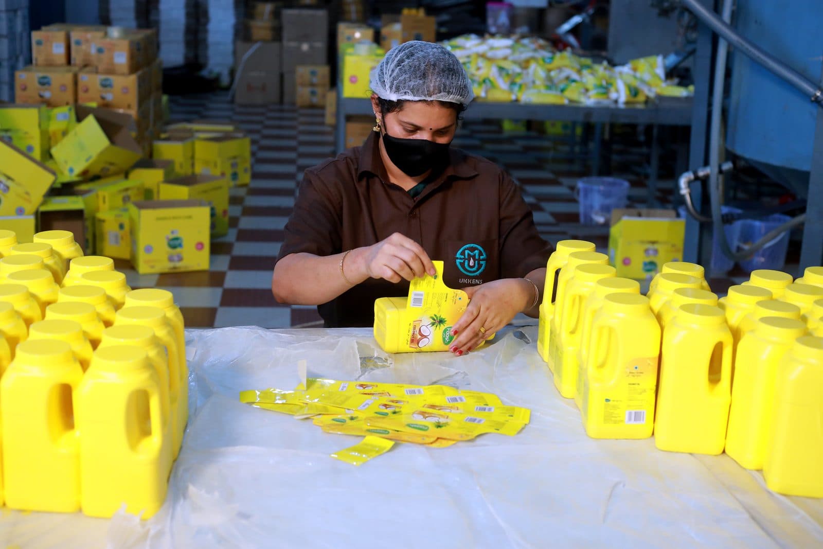 Labels going on, checked can by can